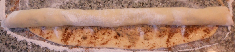 See?  I roll a little on one side, then the middle, then the other side, and it looks like this.  I stopped here, because I prefer to have the end of the dough on top when I cut, but that's a personal preference thing.  You can have the edge up or down.  It doesn't matter.