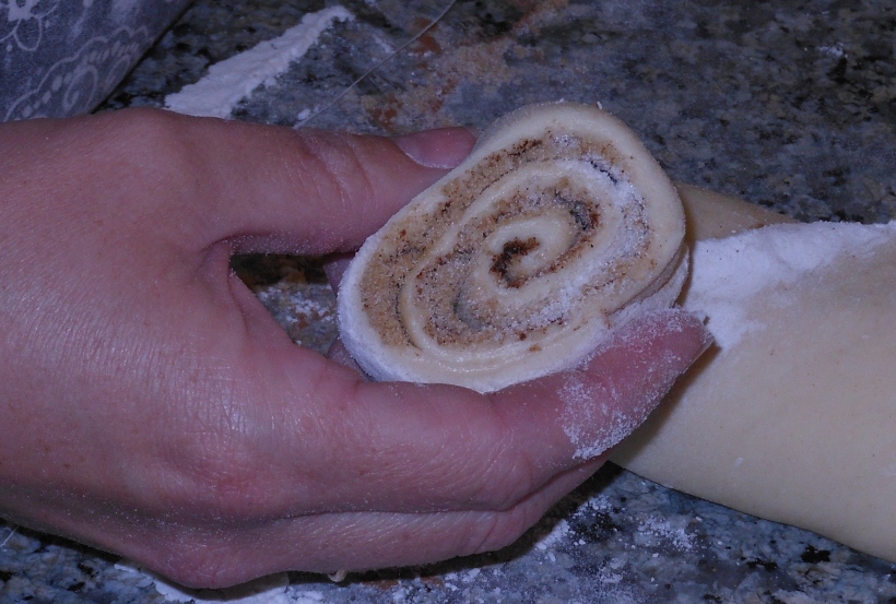 Voila!  You have a perfectly cut cinnamon roll!  Simply place them into a greased pan.  I prefer one with sides like a casserole dish, but you can use a cookie sheet, too.