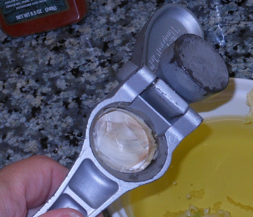 Then I opened up the press and pull out the garlic clove peel.  Easy, Peasy!  I use my garlic press at least 4 days a week every week (unless it's crazy, and I'm not cooking as much).  I've had it for over 5 years and it's still going strong.  It works as well as the first day I got it.  I LOVE IT!  (If you want a good garlic press, check out my friend's Pampered Chef website here.)