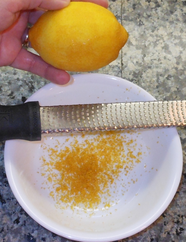 While the crust was baking, I used my Microplane grater to zest my lemon.  I also juiced it and measured out the additional lemon juice needed from my bottled lemon juice.